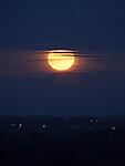 Harvest moon this evening before it went behind the clouds.. Hand held but camera steadied on a tree..